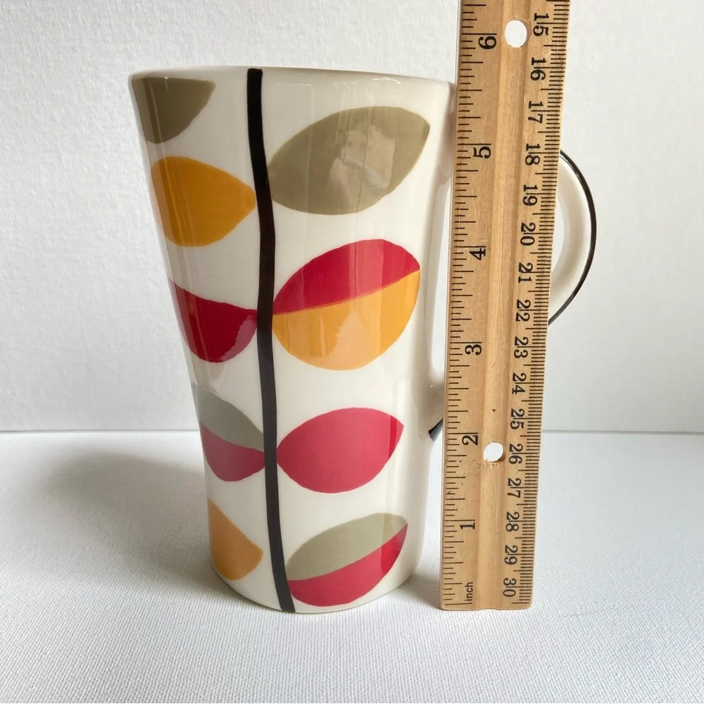 Pier 1 tall asymmetrical oval coffee mug with abstract fall leaves and stripes